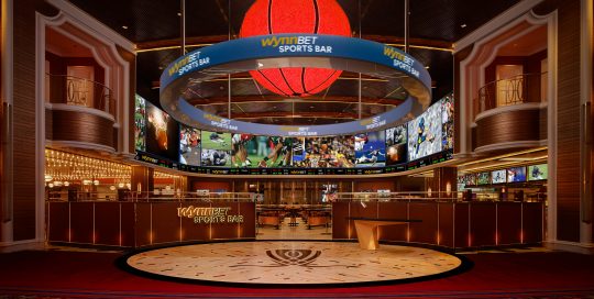 Digital displays showing various sports games & game data in the WynnBET Sports Bar