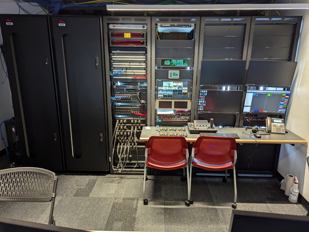 IT closet with racks of servers and various controllers