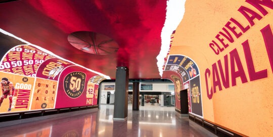 An indoor walkway/tunnel with 360 degree digital displays showing Cleveland Cavalier graphics
