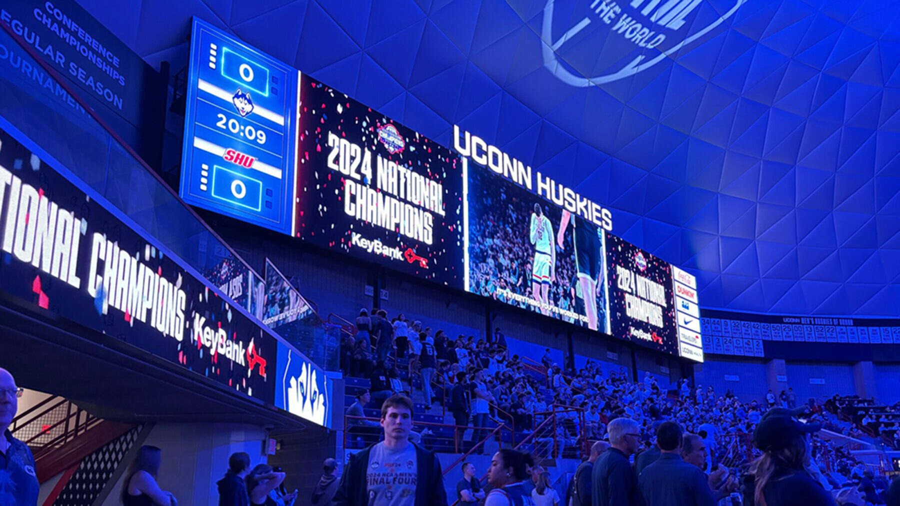 Digital scoreboard displaying graphics celebrating the 2024 National Champions at the UConn Huskies basketball game
