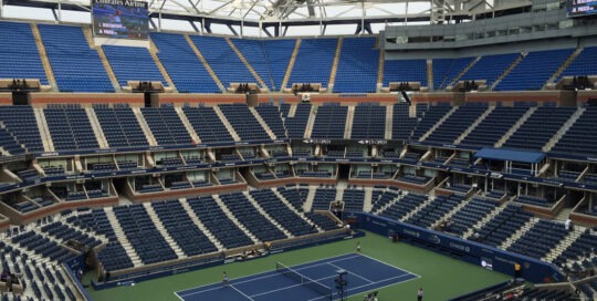 Tennis court with the roof partially retracted at the Arthur Ashe Stadium
